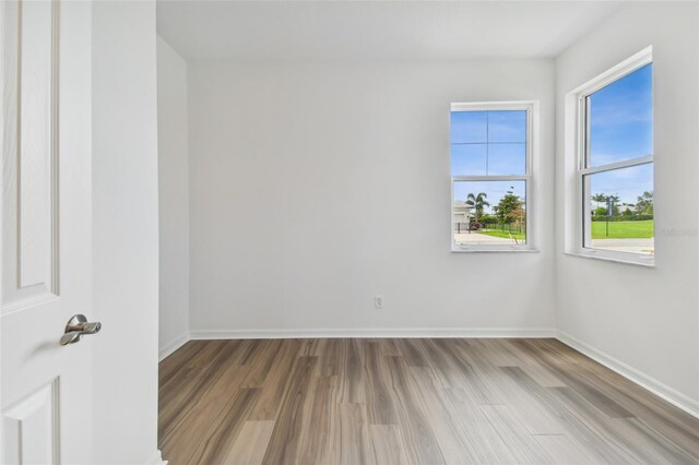 unfurnished room featuring hardwood / wood-style floors