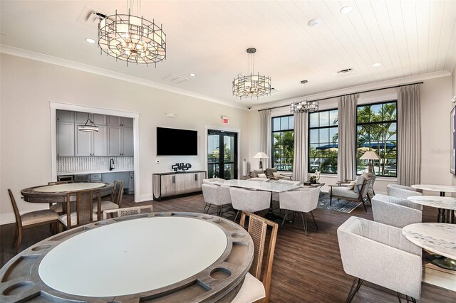 dining room featuring ornamental molding, dark hardwood / wood-style floors, and a chandelier