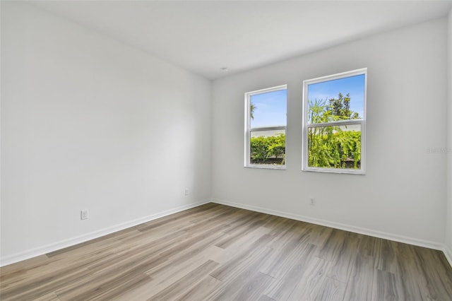 unfurnished room with light wood-type flooring