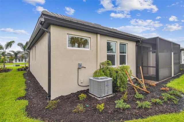 exterior space with central air condition unit and a lawn