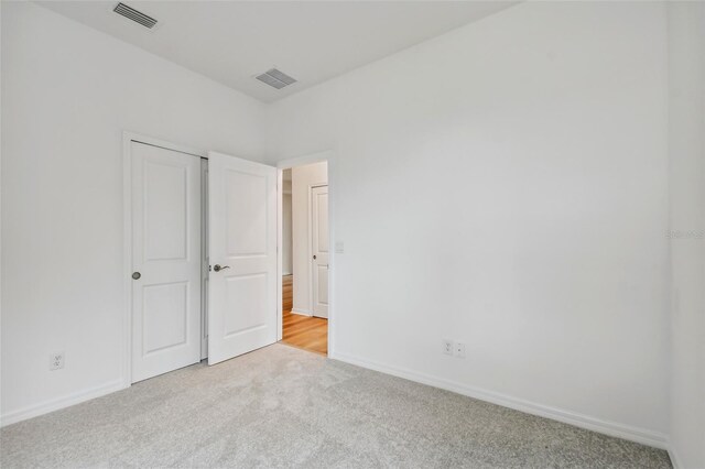 unfurnished bedroom featuring light carpet