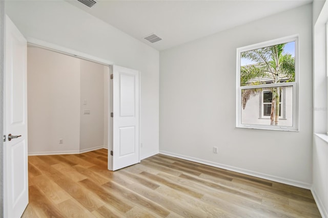 unfurnished room with light wood-type flooring