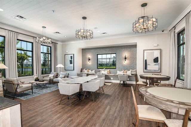 dining area with a notable chandelier, dark hardwood / wood-style flooring, and ornamental molding