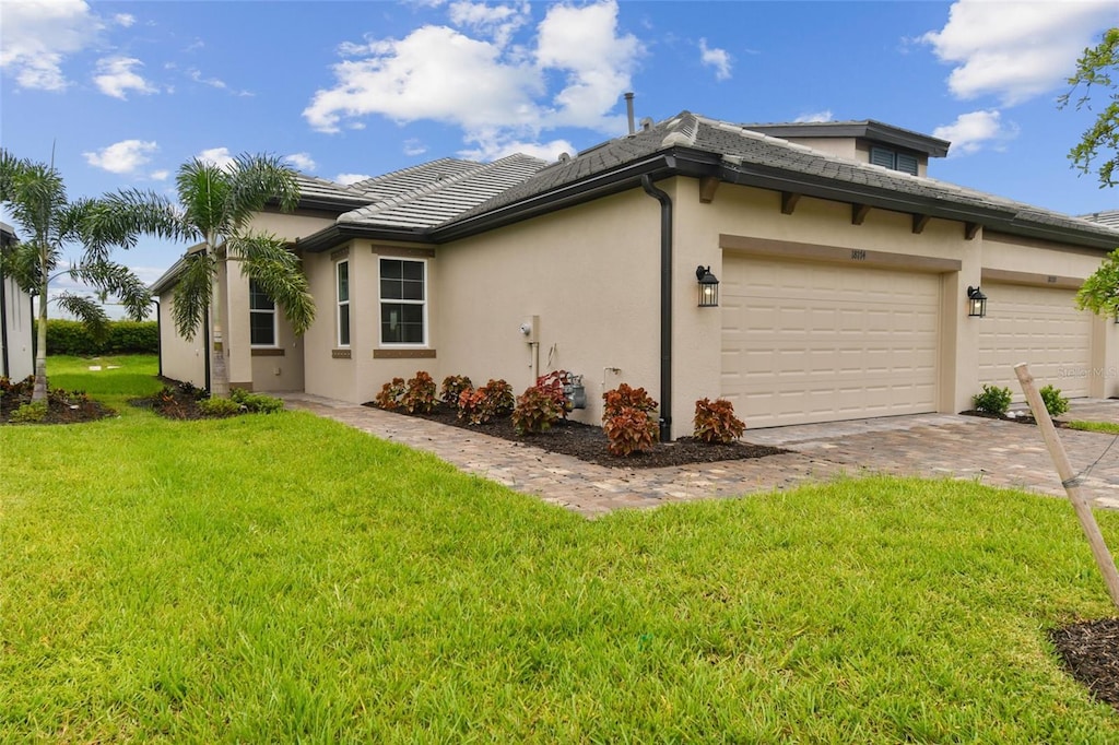 view of side of home with a lawn and a garage