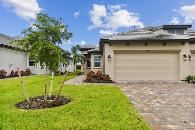 view of front of home with a front yard and a garage