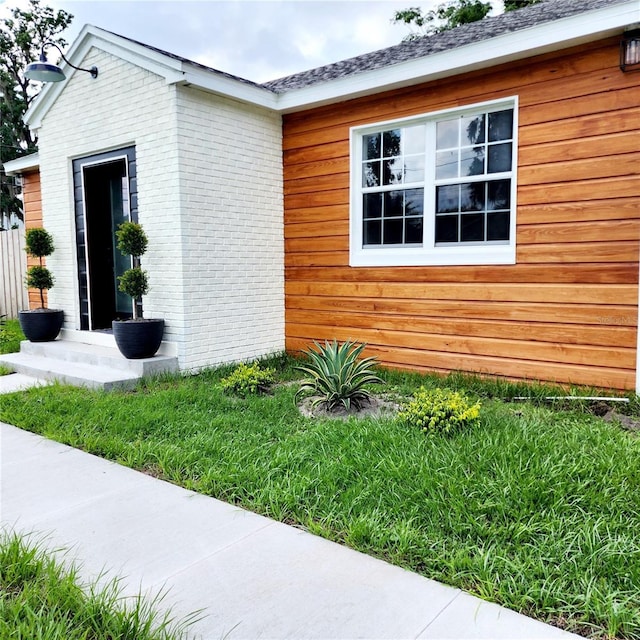 view of side of property with brick siding