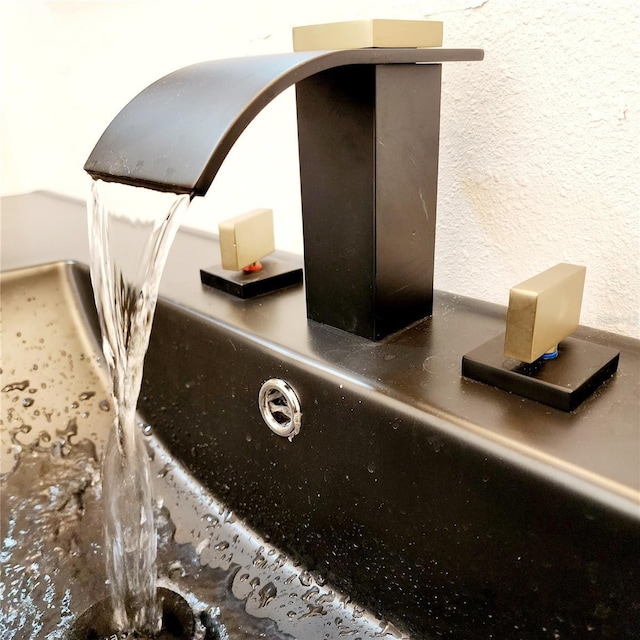 room details featuring a textured wall and a sink