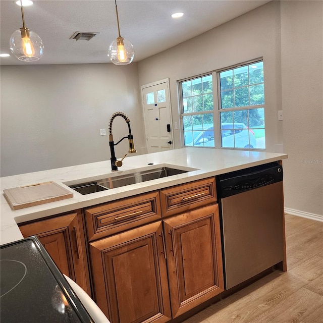 kitchen with pendant lighting, light wood-type flooring, stainless steel dishwasher, and sink