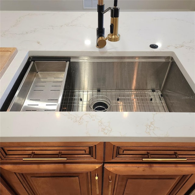 details with a sink and brown cabinetry