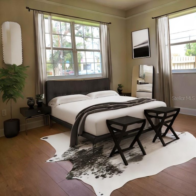 bedroom featuring baseboards and wood finished floors