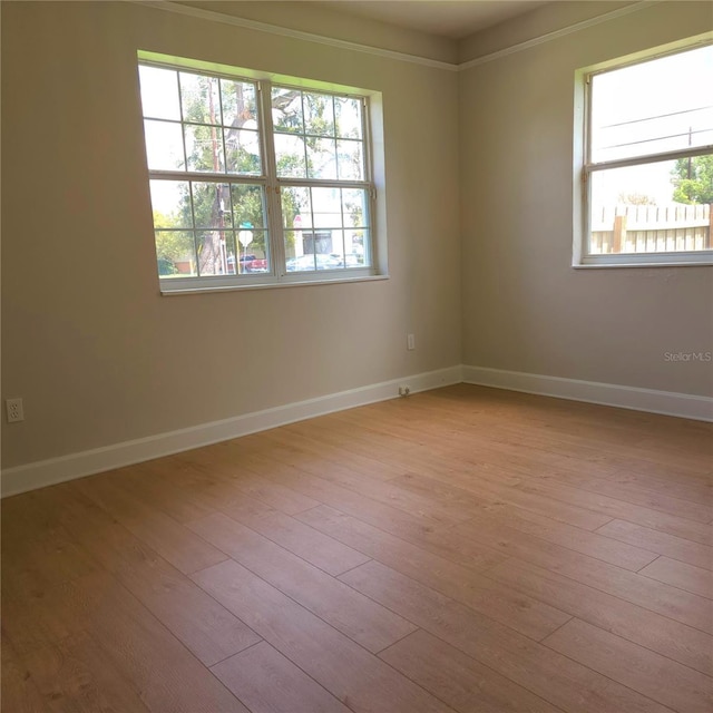 empty room with wood finished floors and baseboards