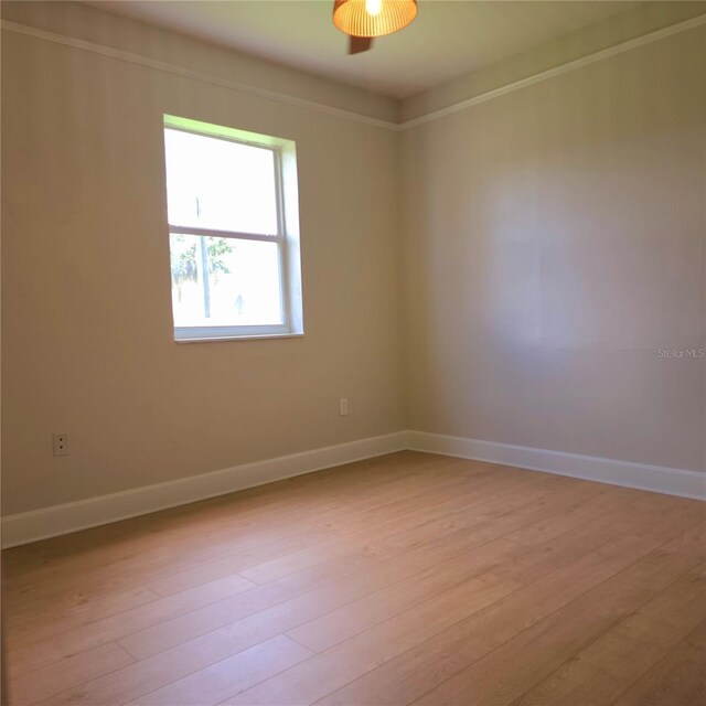 unfurnished room with ceiling fan and light wood-type flooring