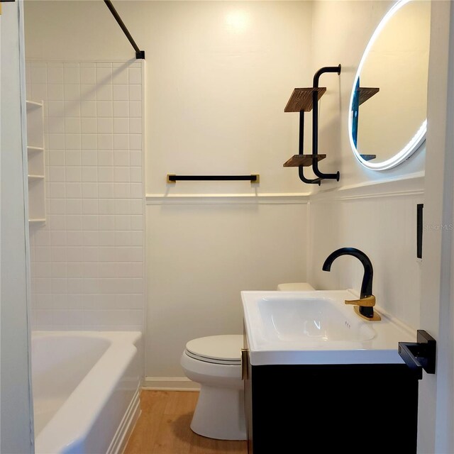 full bathroom with vanity, wood-type flooring, shower / bathtub combination, and toilet