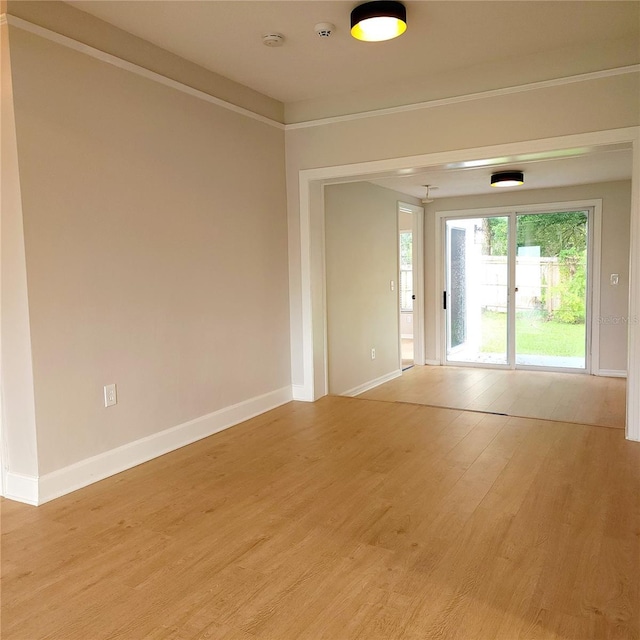 spare room with light wood-style flooring and baseboards