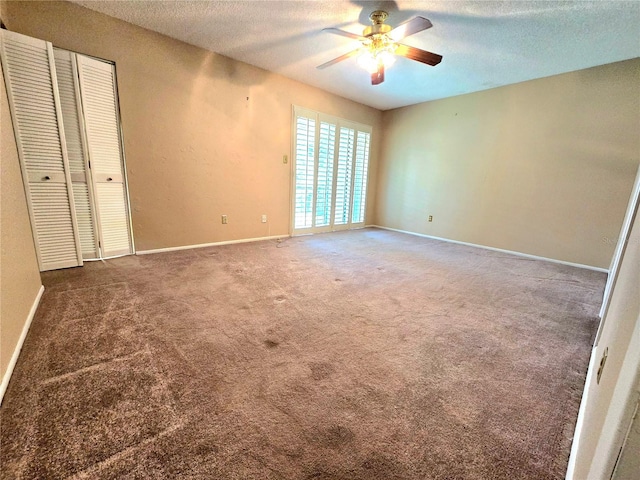 interior space featuring ceiling fan and a textured ceiling