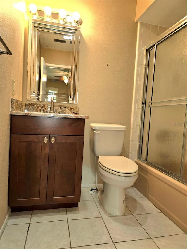 full bathroom featuring tile patterned flooring, vanity, enclosed tub / shower combo, and toilet