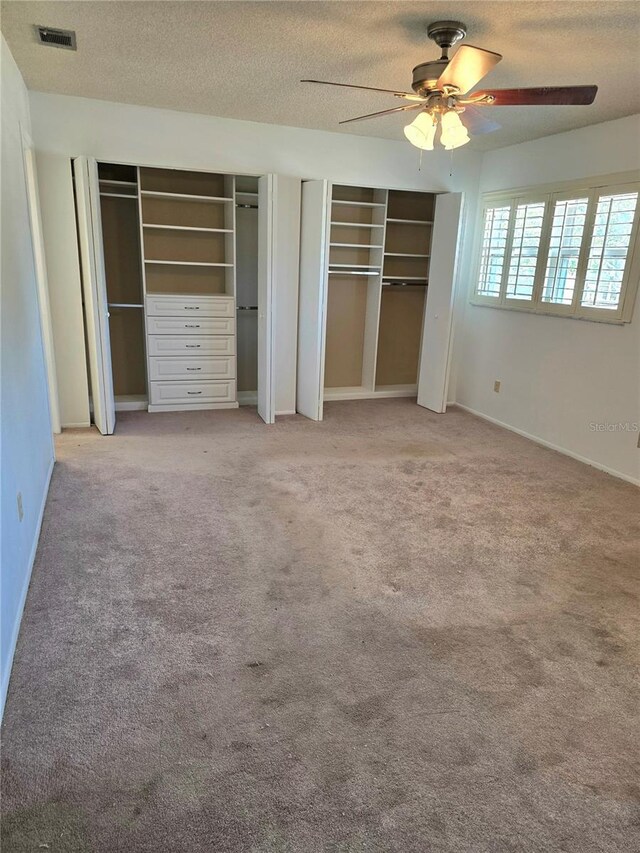 1019 Grove St Unit 85, Maitland, FL 32751 - unfurnished bedroom with visible vents, light colored carpet, a textured ceiling, and two closets