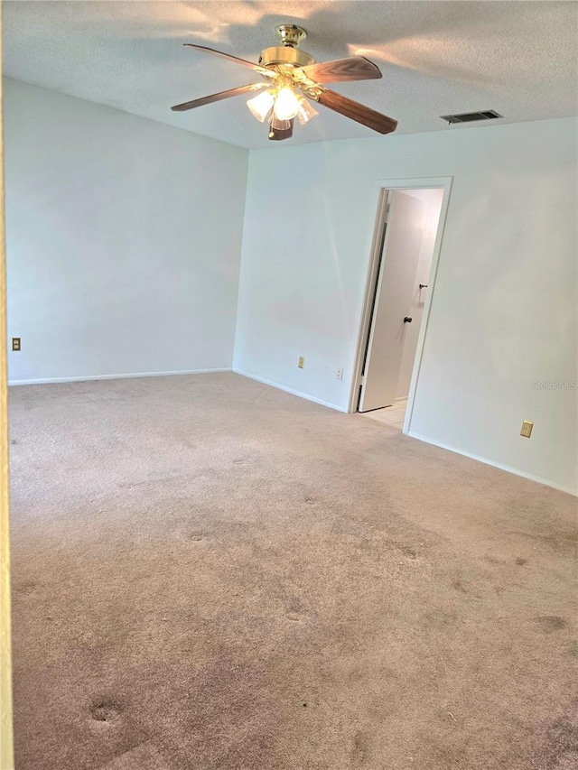 1019 Grove St Unit 85, Maitland, FL 32751 - empty room with a textured ceiling, light colored carpet, visible vents, baseboards, and a ceiling fan