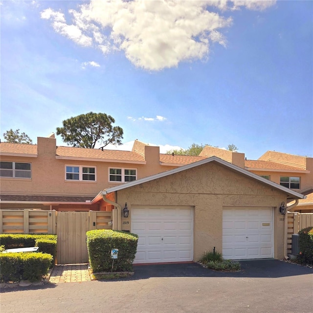 1019 Grove St Unit 85, Maitland, FL 32751 - view of property with fence, aphalt driveway, and stucco siding