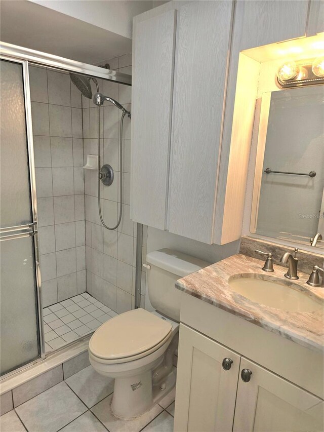1019 Grove St Unit 85, Maitland, FL 32751 - full bathroom with tile patterned floors, a shower stall, toilet, and vanity