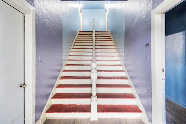 staircase featuring hardwood / wood-style flooring