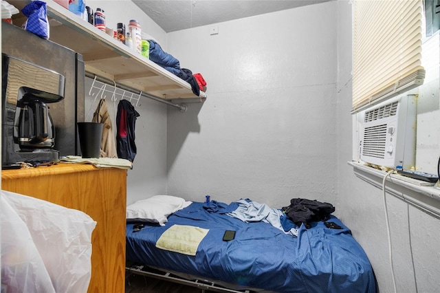 bedroom featuring cooling unit and a textured ceiling