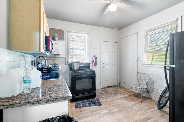 kitchen featuring ceiling fan, sink, light brown cabinets, black appliances, and light wood-type flooring