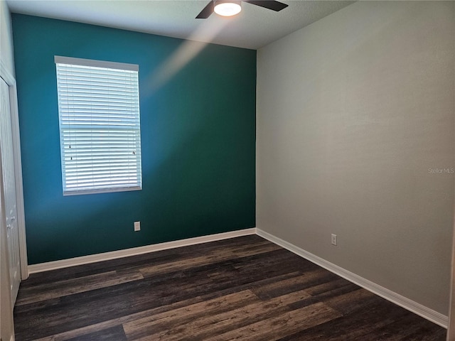 unfurnished room with ceiling fan and dark hardwood / wood-style flooring