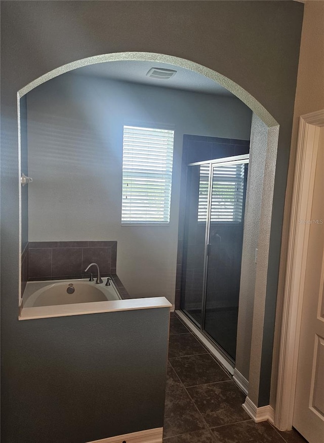 bathroom featuring independent shower and bath and tile patterned flooring