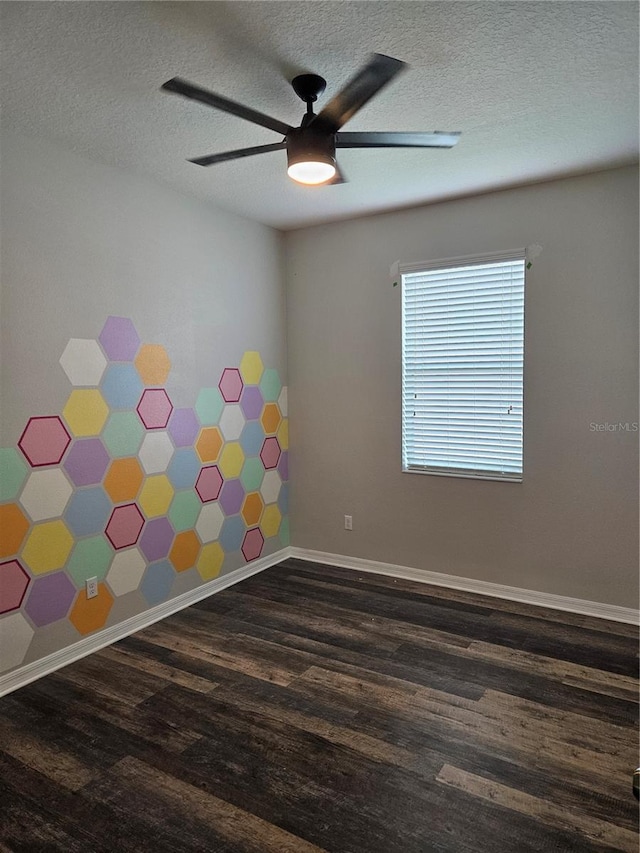 spare room with ceiling fan, a textured ceiling, and dark hardwood / wood-style flooring