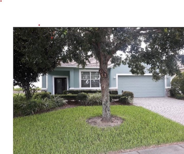 view of front facade with a front yard and a garage