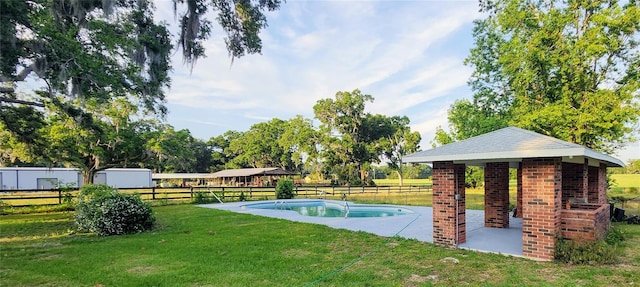 view of pool featuring a yard