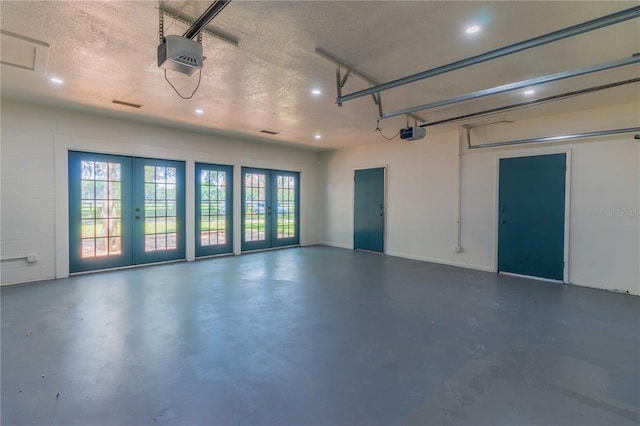 garage featuring a garage door opener and french doors