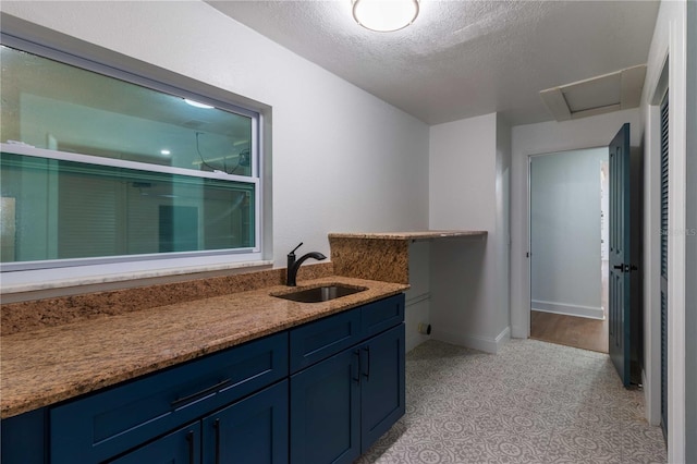 bathroom with vanity and a textured ceiling