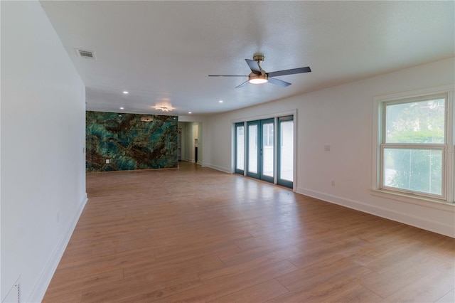 unfurnished room featuring ceiling fan and light hardwood / wood-style flooring