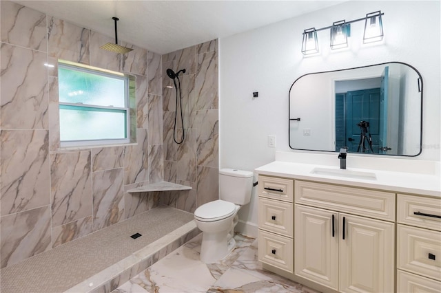 bathroom with toilet, vanity, and tiled shower