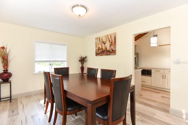 dining space with light wood-type flooring