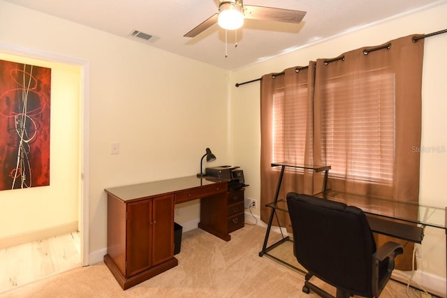 home office featuring light colored carpet and ceiling fan