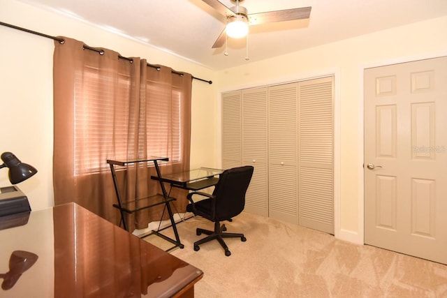 carpeted home office featuring ceiling fan