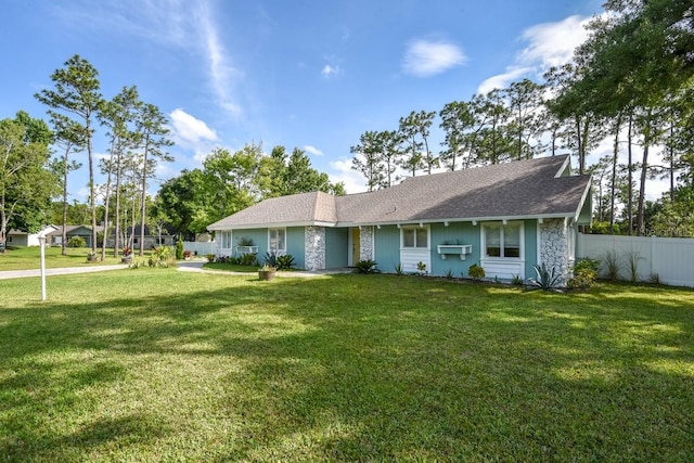 ranch-style home featuring a front yard