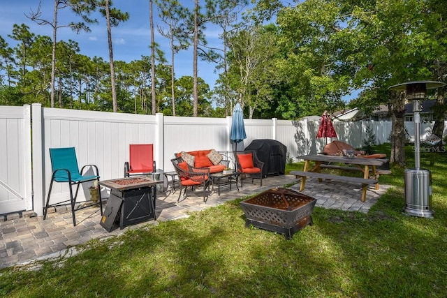 view of patio / terrace featuring a grill and a fire pit