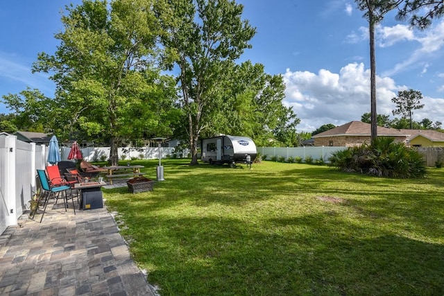 view of yard featuring a fire pit and a patio area