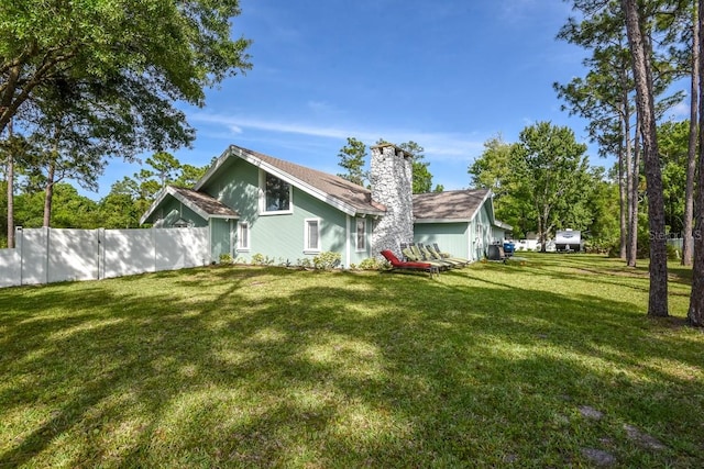 back of house with a lawn