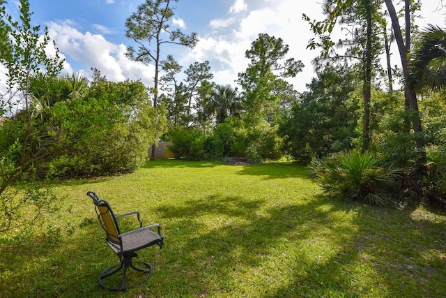 view of property's community with a lawn