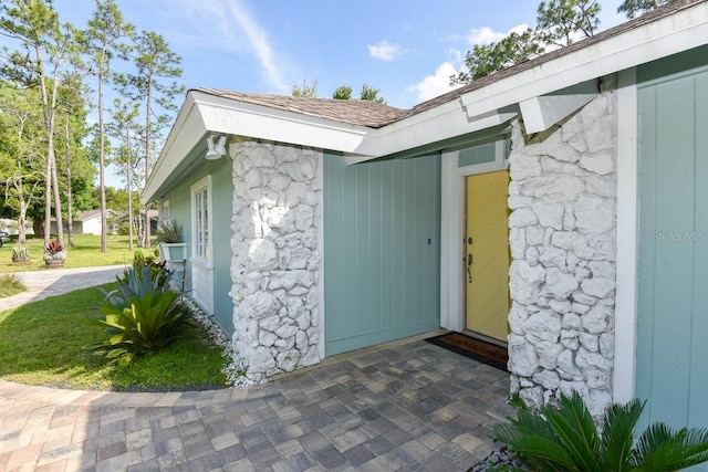 property entrance featuring a lawn