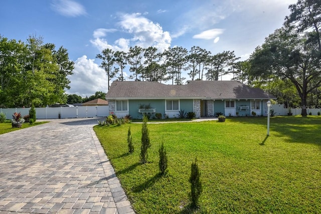 ranch-style home with a front lawn