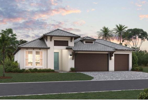 view of front facade with a garage and a lawn