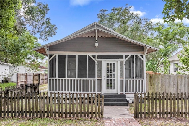 view of front of house featuring a sunroom