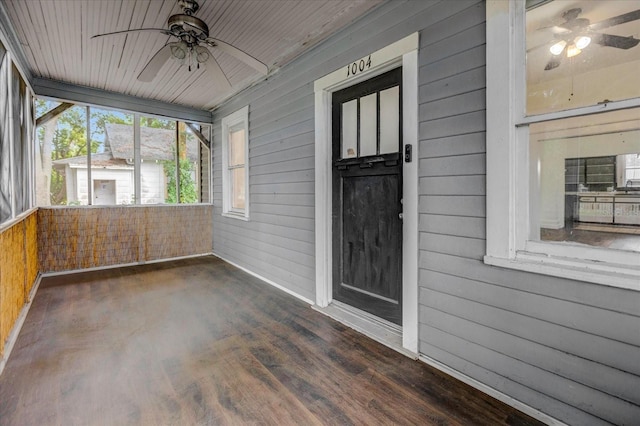 unfurnished sunroom featuring ceiling fan