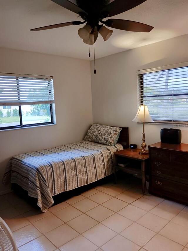 tiled bedroom with ceiling fan